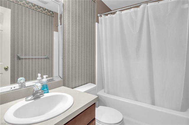 full bath with toilet, wallpapered walls, shower / bath combination with curtain, and vanity