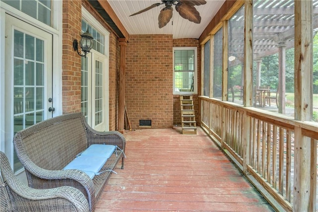 sunroom / solarium with visible vents and ceiling fan