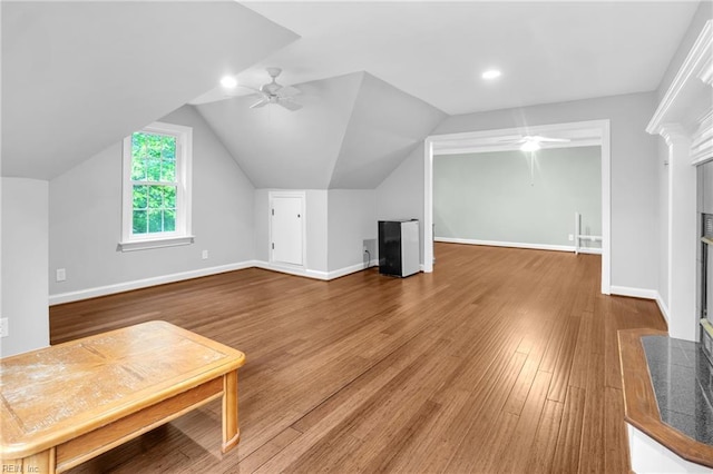 additional living space featuring baseboards, ceiling fan, wood finished floors, and lofted ceiling