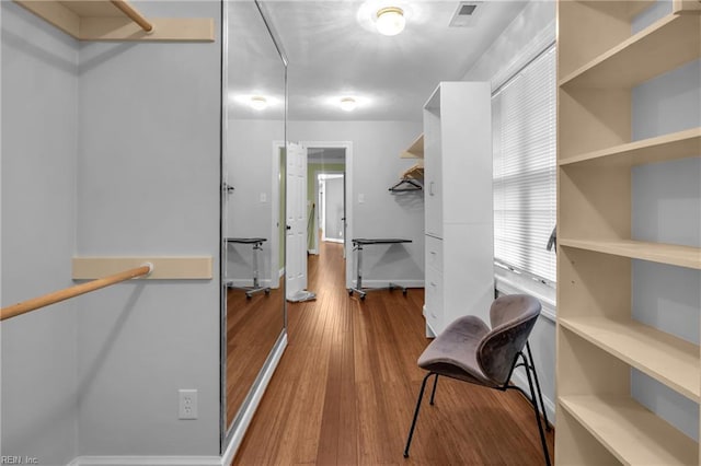 walk in closet with wood finished floors and visible vents