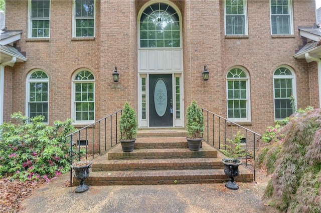 entrance to property featuring brick siding