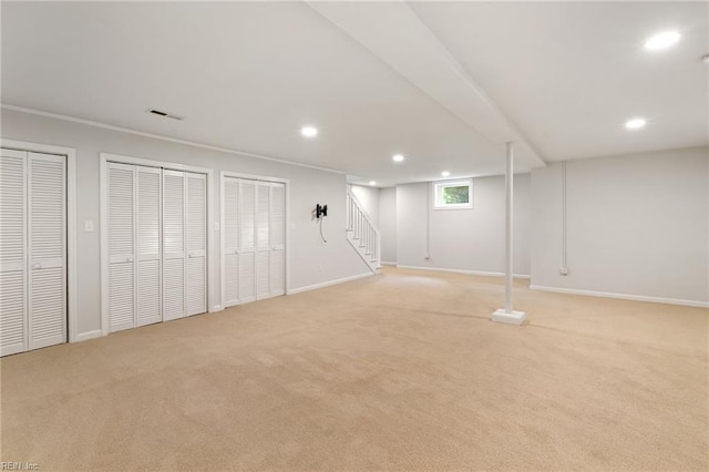 basement featuring recessed lighting, visible vents, light carpet, and stairway