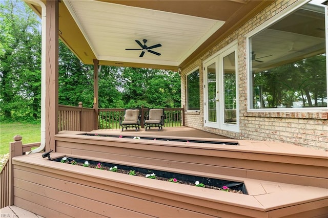 deck with french doors and a ceiling fan