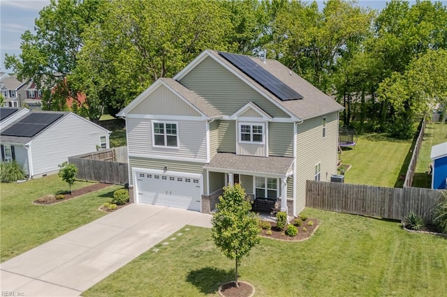 view of front of property featuring covered porch, solar panels, fence, concrete driveway, and an attached garage