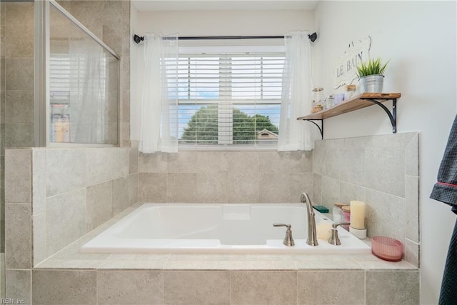 full bath with a bath and tiled shower