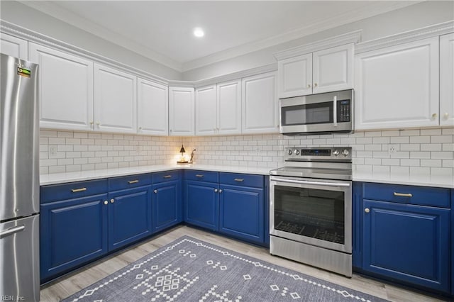 kitchen with light countertops, blue cabinets, light wood-style flooring, and stainless steel appliances