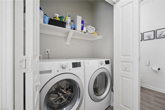 laundry room with baseboards, separate washer and dryer, laundry area, and wood finished floors