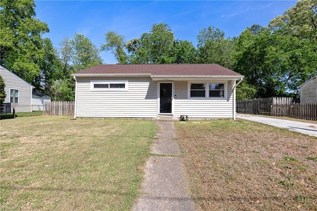 bungalow with fence and a front yard