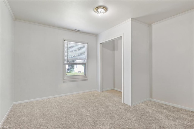 unfurnished bedroom with a closet, ornamental molding, carpet, and baseboards