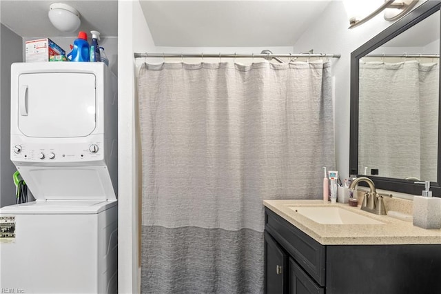 bathroom with vanity and stacked washer and clothes dryer
