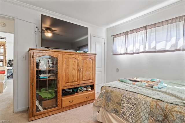 bedroom featuring crown molding and light carpet