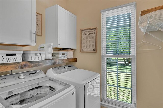 laundry room with cabinet space and washer and clothes dryer