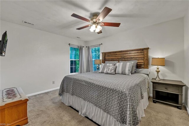 bedroom featuring carpet floors, baseboards, visible vents, and ceiling fan