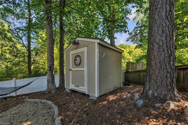 view of shed featuring fence