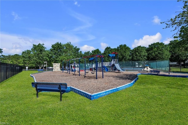 communal playground featuring fence and a yard