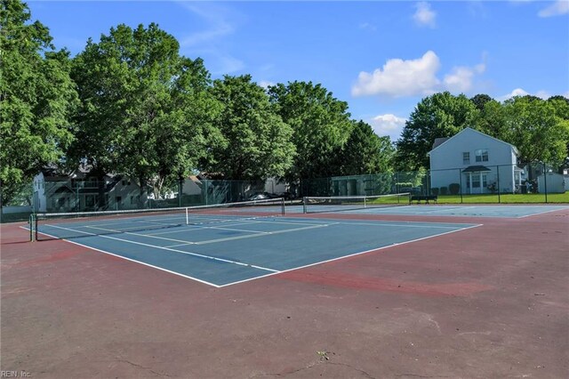 view of tennis court featuring fence and community basketball court