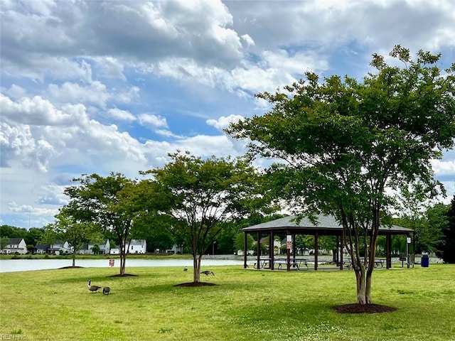 surrounding community with a lawn, a gazebo, and a water view
