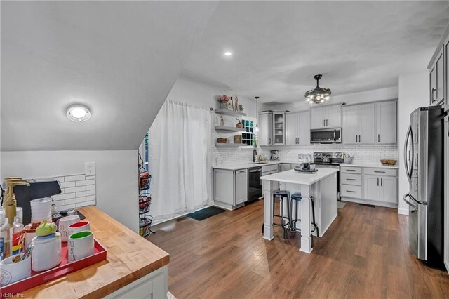 kitchen featuring decorative backsplash, a sink, appliances with stainless steel finishes, and light countertops