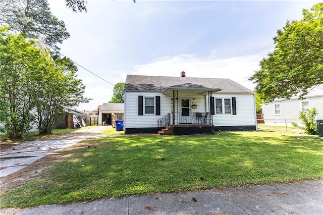 bungalow featuring fence, a front yard, a chimney, crawl space, and driveway