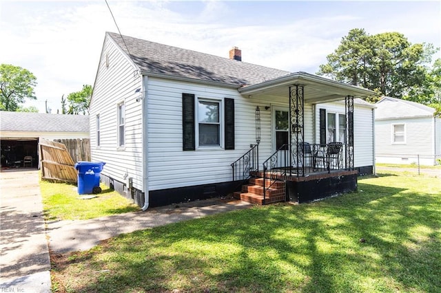 bungalow-style home featuring fence, a front yard, roof with shingles, a chimney, and a porch