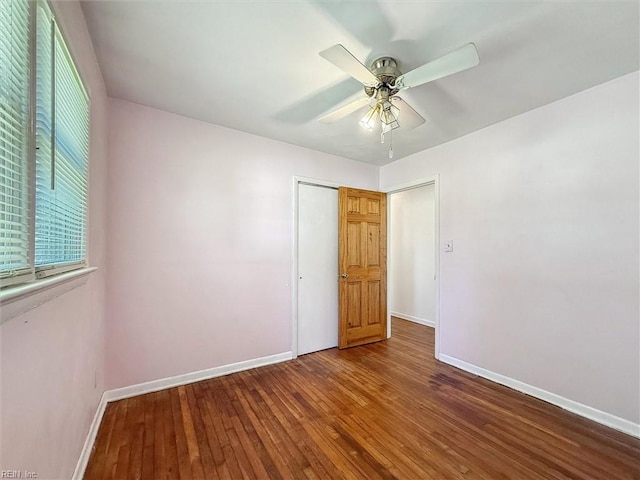 empty room with a ceiling fan, baseboards, and hardwood / wood-style floors