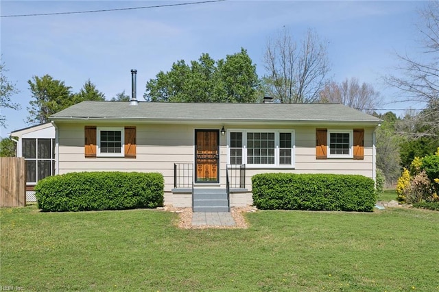 ranch-style house featuring a sunroom and a front yard