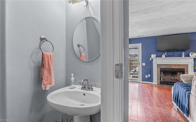3116 Crosstimber Way, Virginia Beach, VA 23456 - bathroom featuring a sink, a fireplace, and wood finished floors