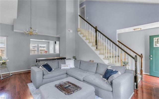 3116 Crosstimber Way, Virginia Beach, VA 23456 - living room featuring a towering ceiling, wood finished floors, baseboards, stairway, and a notable chandelier