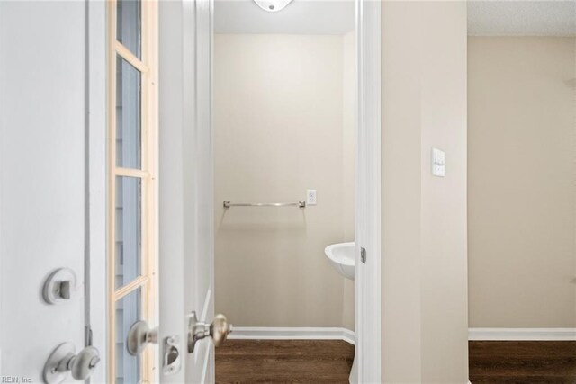 bathroom with baseboards and wood finished floors