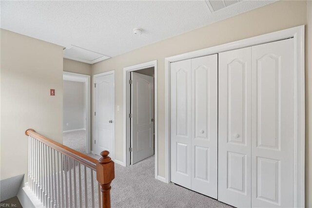 corridor featuring baseboards, visible vents, and carpet