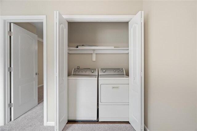 laundry room featuring independent washer and dryer, laundry area, baseboards, and carpet flooring