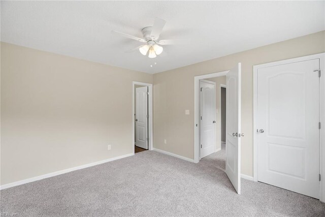 unfurnished bedroom with baseboards, ceiling fan, and light colored carpet