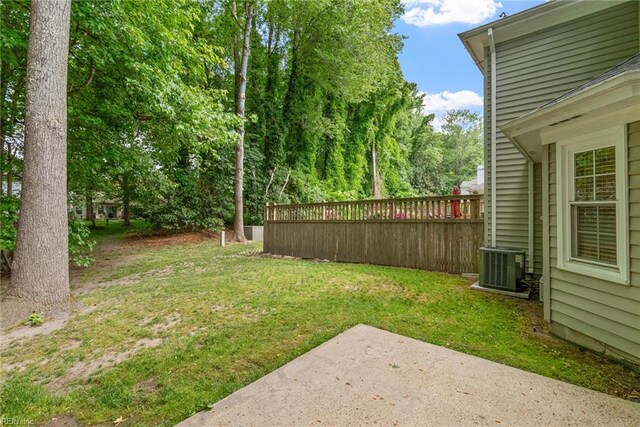 view of yard with central air condition unit and a patio area
