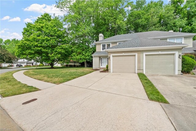 view of front of house featuring a chimney, a front yard, a garage, concrete driveway, and a shingled roof