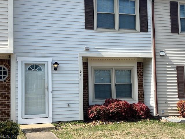entrance to property featuring brick siding