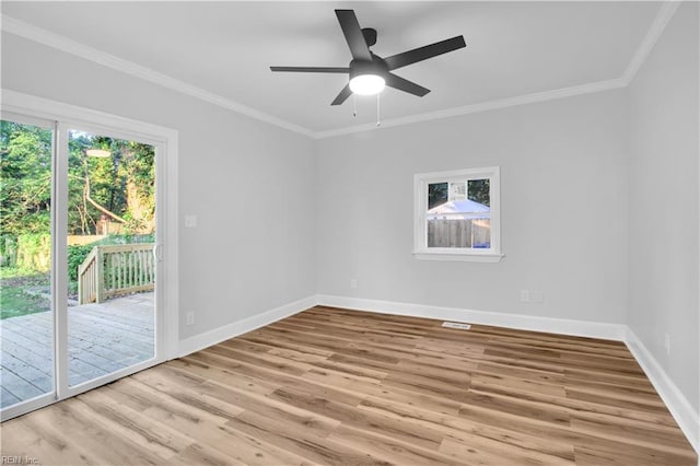 empty room featuring baseboards, ornamental molding, a ceiling fan, and wood finished floors