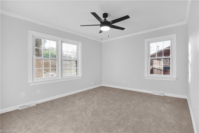 unfurnished room with visible vents, ornamental molding, and plenty of natural light