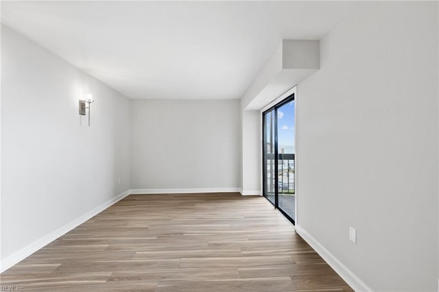 2830 Shore Dr Unit 405, Virginia Beach, VA 23451 - spare room with baseboards and wood finished floors