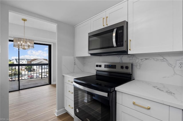 2830 Shore Dr Unit 405, Virginia Beach, VA 23451 - kitchen featuring white cabinetry, tasteful backsplash, a chandelier, and stainless steel appliances