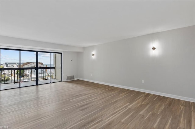 2830 Shore Dr Unit 405, Virginia Beach, VA 23451 - spare room featuring baseboards, visible vents, and wood finished floors