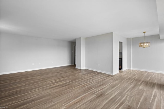 2830 Shore Dr Unit 405, Virginia Beach, VA 23451 - unfurnished living room with baseboards, a chandelier, and wood finished floors