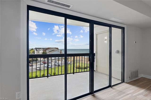 2830 Shore Dr Unit 405, Virginia Beach, VA 23451 - doorway to outside with a water view, baseboards, wood finished floors, and visible vents