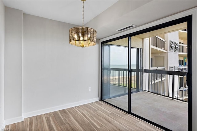 2830 Shore Dr Unit 405, Virginia Beach, VA 23451 - spare room with baseboards, visible vents, wood finished floors, and a notable chandelier