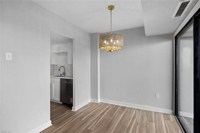 2830 Shore Dr Unit 405, Virginia Beach, VA 23451 - unfurnished dining area with visible vents, wood finished floors, a sink, baseboards, and an inviting chandelier