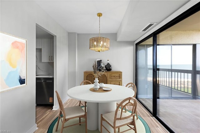 2830 Shore Dr Unit 405, Virginia Beach, VA 23451 - dining space featuring visible vents, light wood-style flooring, and an inviting chandelier