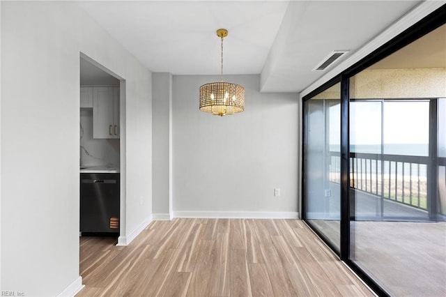 2830 Shore Dr Unit 405, Virginia Beach, VA 23451 - unfurnished dining area with light wood-style floors, baseboards, a chandelier, and visible vents