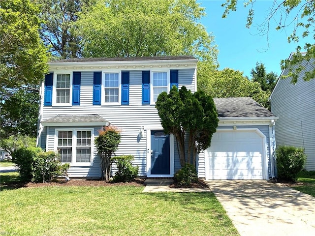 colonial inspired home featuring driveway, a front yard, and a garage