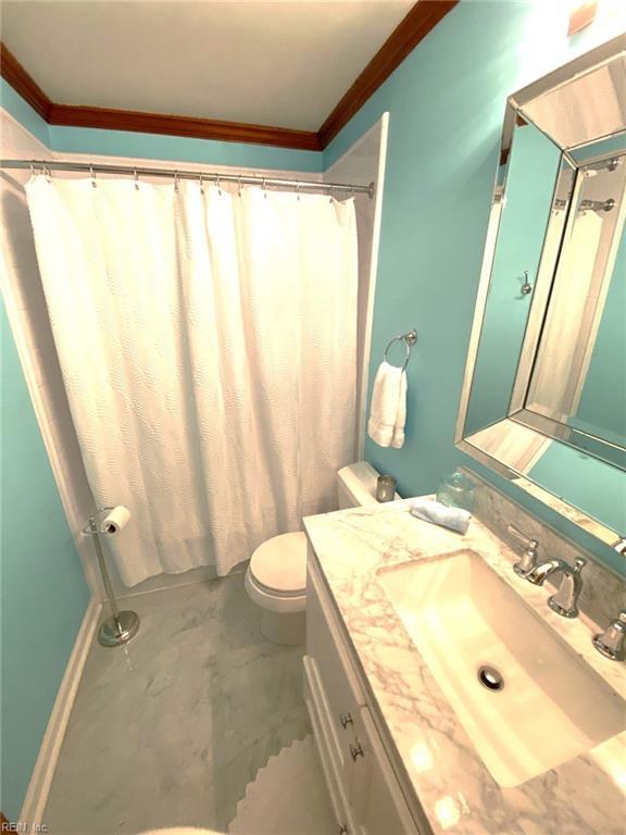 bathroom featuring crown molding, toilet, concrete flooring, and vanity