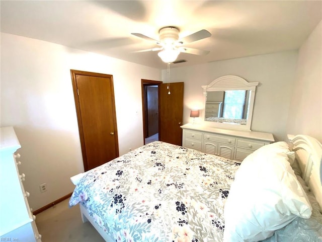 bedroom featuring ceiling fan, light carpet, baseboards, visible vents, and a closet