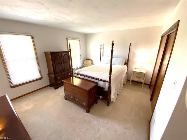 bedroom featuring baseboards and light carpet